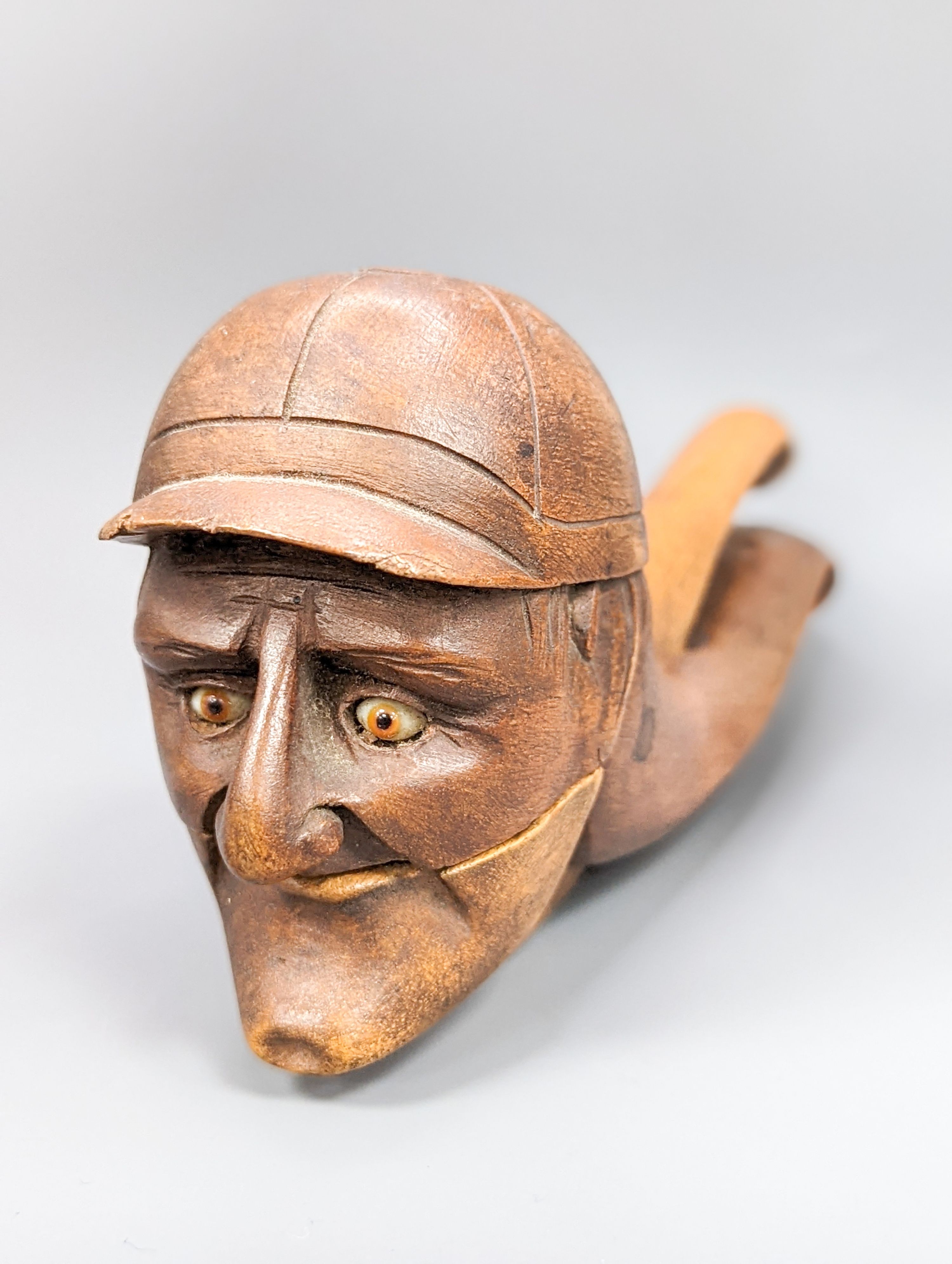 A pair of Victorian treen nutcrackers, in the form of a jockey’s head, glass in set eyes, length 20cm